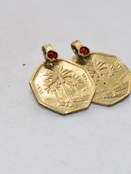 Our Arabic Gold Coin Earrings are a unique and sophisticated cultural statement, showcasing the rich heritage of the Iran Islamic State through a meticulously crafted gold coin design featuring a date palm tree.