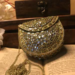 Elevate your style with the Mini Kundan Clutch, featuring exquisite crystal inlays and a regal gold clasp, blending tradition with modern luxury effortlessly.