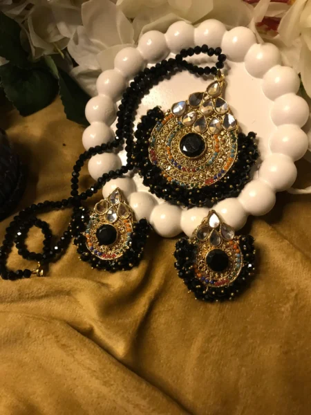 Explore charm of Simple Artificial Jewellery Sets,highlights the stunning contrast of faceted black beads, gold filigree pendants, & matching earrings set
