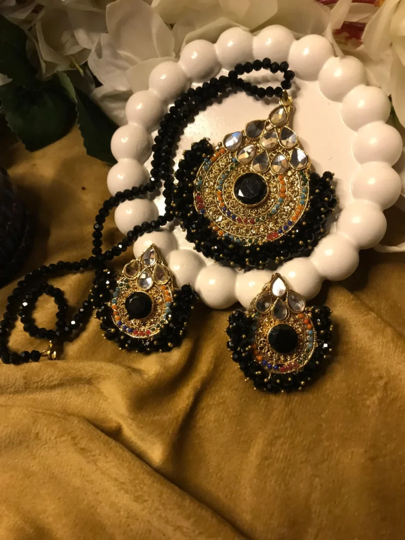 Explore charm of Simple Artificial Jewellery Sets,highlights the stunning contrast of faceted black beads, gold filigree pendants, & matching earrings set