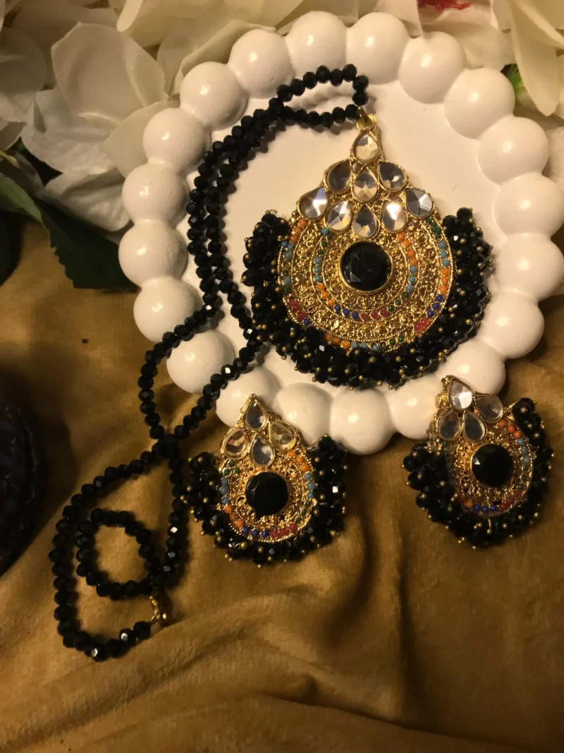 Explore charm of Simple Artificial Jewellery Sets,highlights the stunning contrast of faceted black beads, gold filigree pendants, & matching earrings set